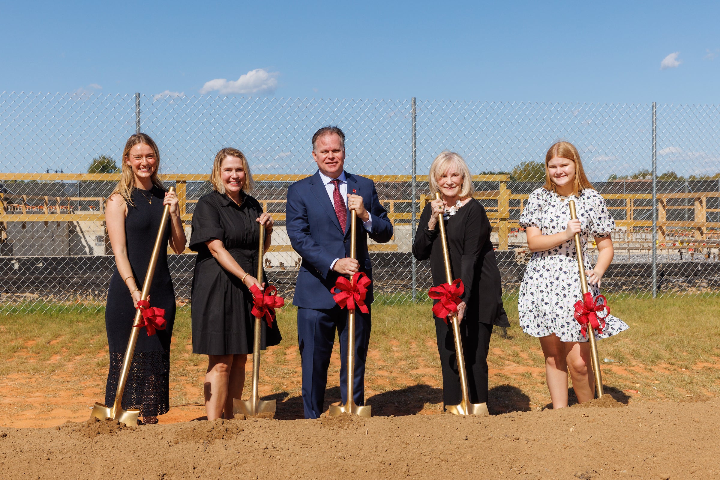 Members of the Smith family holding shovels at the performing arts center groundbreaking