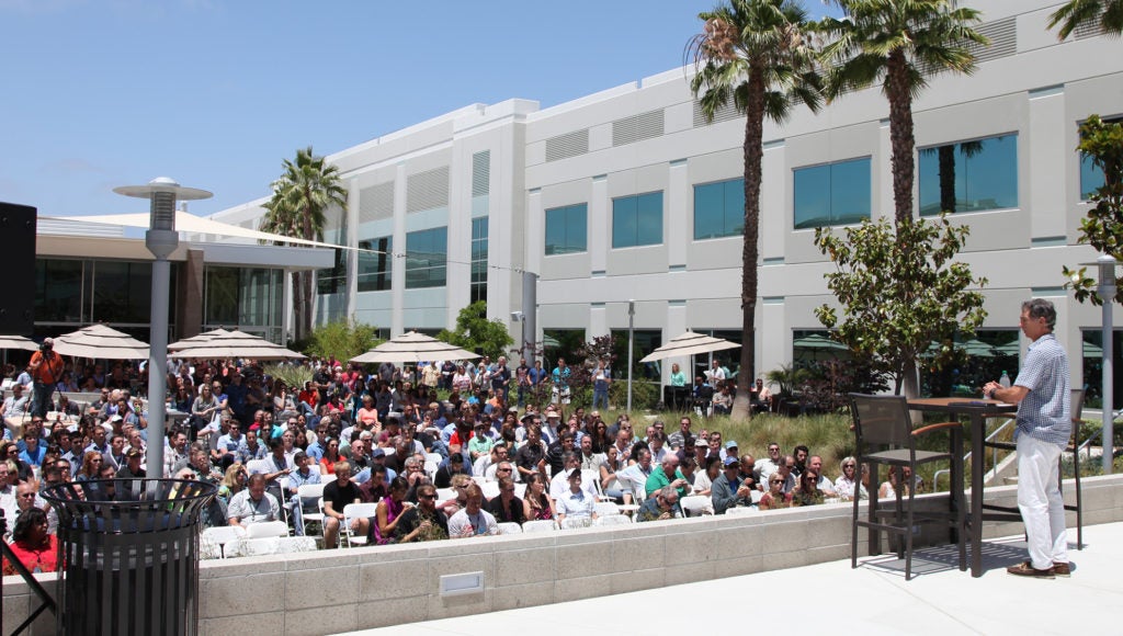 Mark Dankberg, at right, speaking to employees gathered outdoors at Viasat’s Carlsbad campus