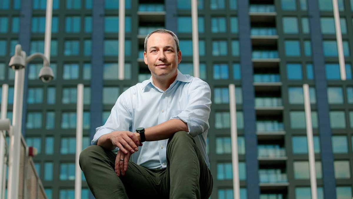 Mark Frank seated outdoors in a city setting