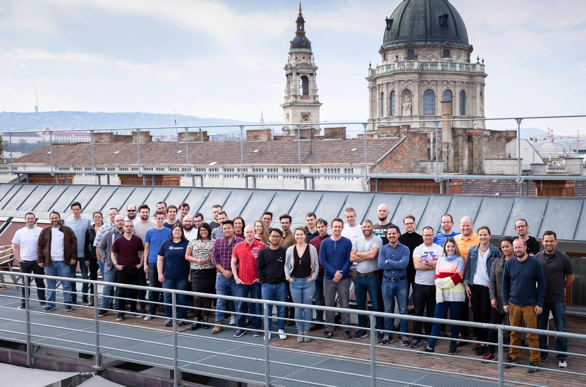 Kinsta colleagues gathered together on a rooftop at a team meetup