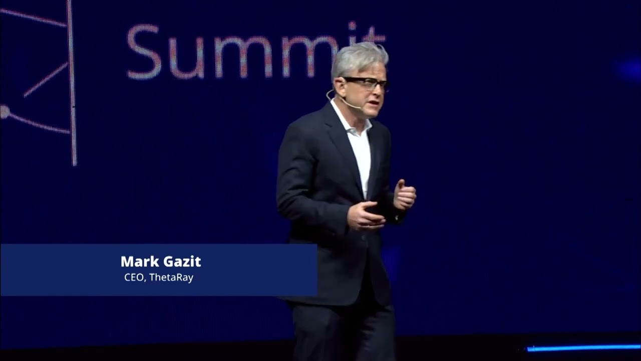 Mark Gazit speaking on stage at an OurCrowd Summit during his ThetaRay CEO tenure