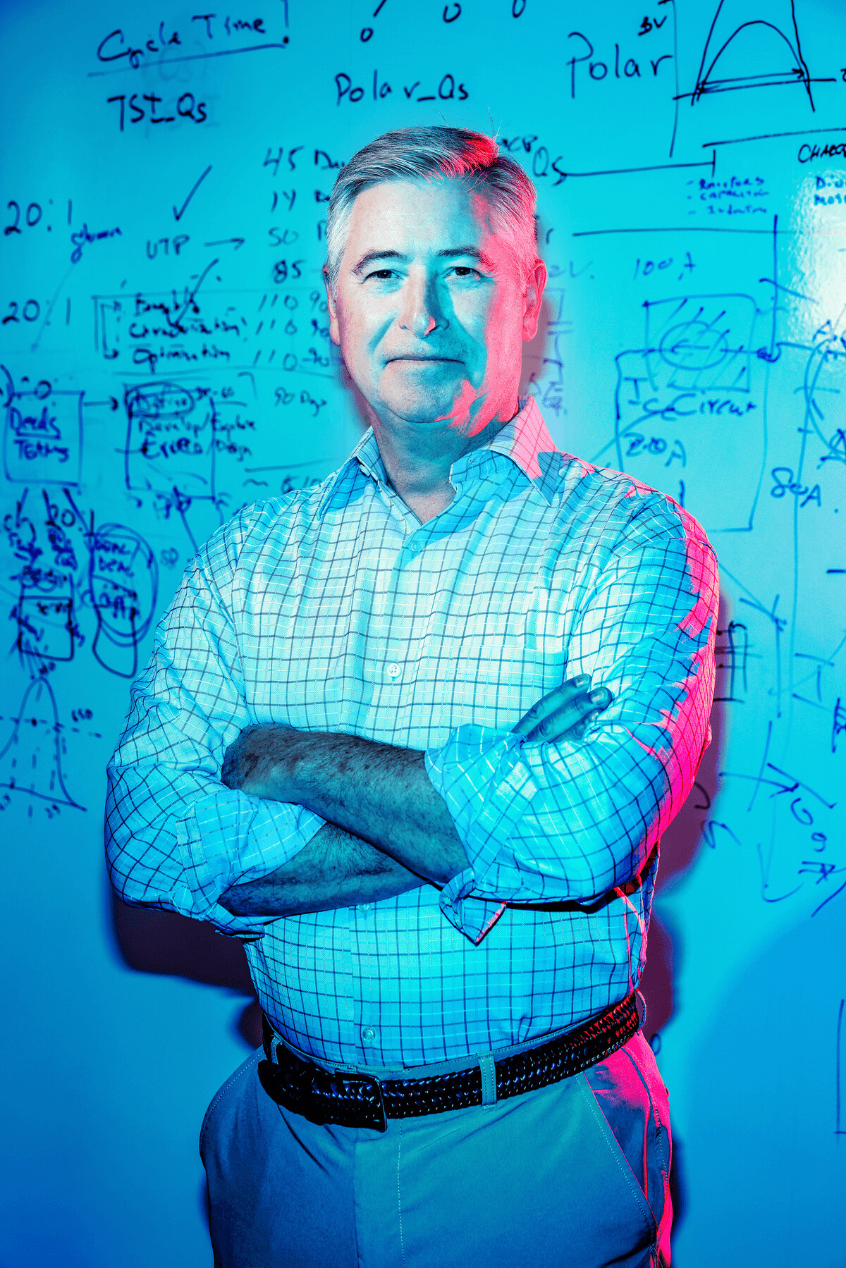 Mark Granahan standing in front of a whiteboard filled with semiconductor diagrams
