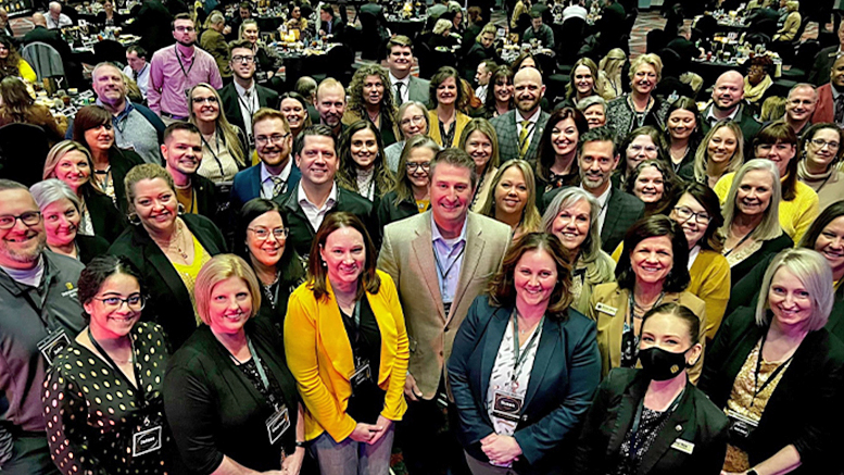 Mark Hardwick standing near the center of a large group of First Merchants colleagues at an event