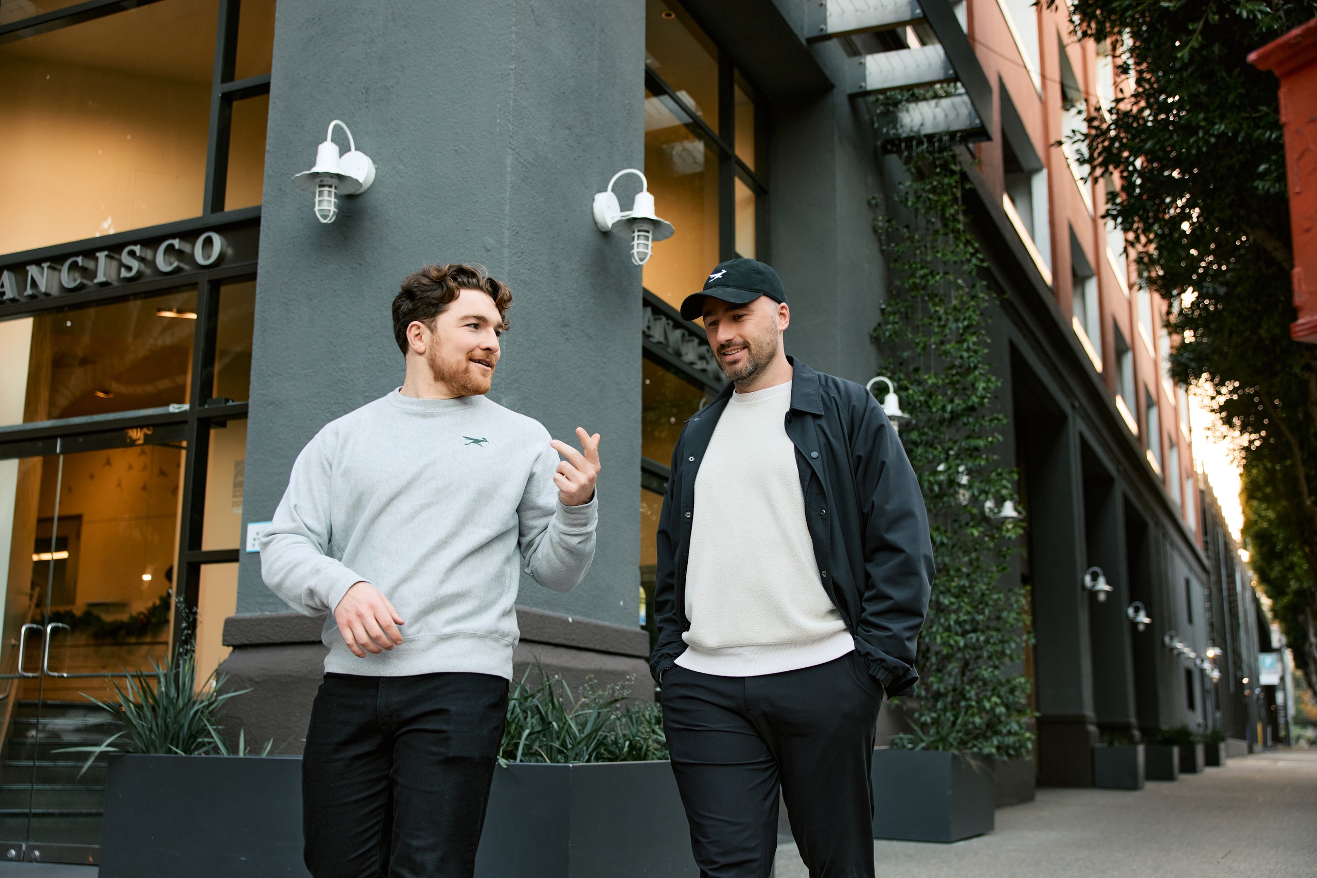 Patrick Finlay, left, and Mark Hughes, right, talking outside a building in San Francisco