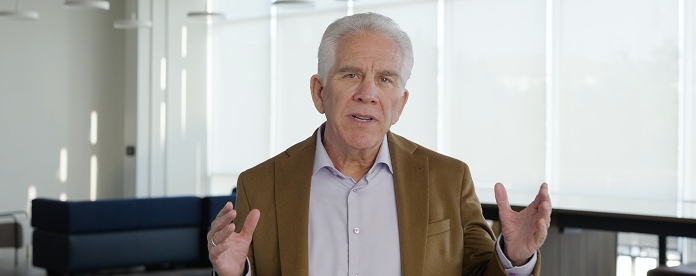 Mark McClain gesturing as he speaks in a bright SailPoint office