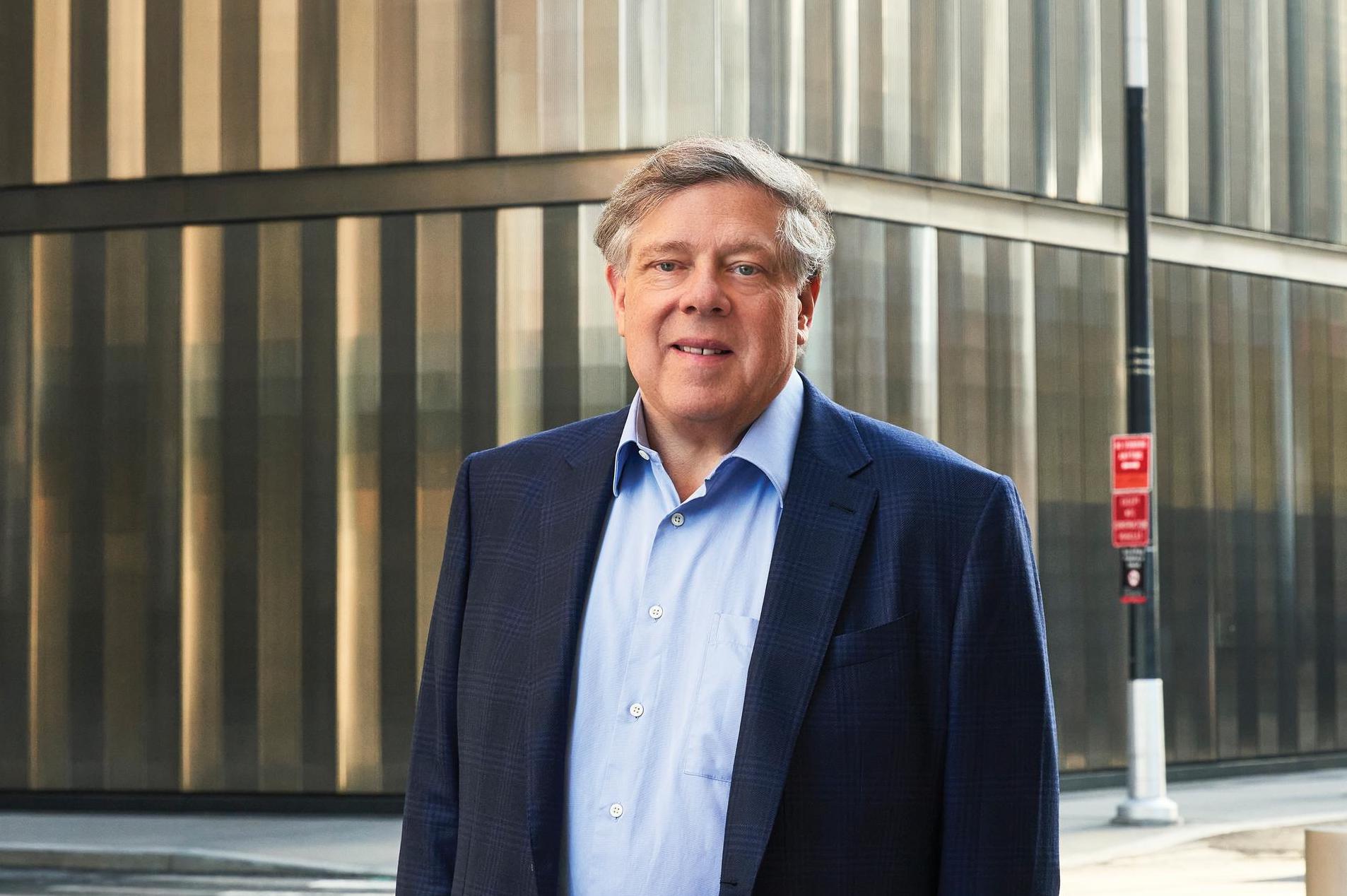 Mark Penn in a blue jacket outside a building in a Stagwell press photograph