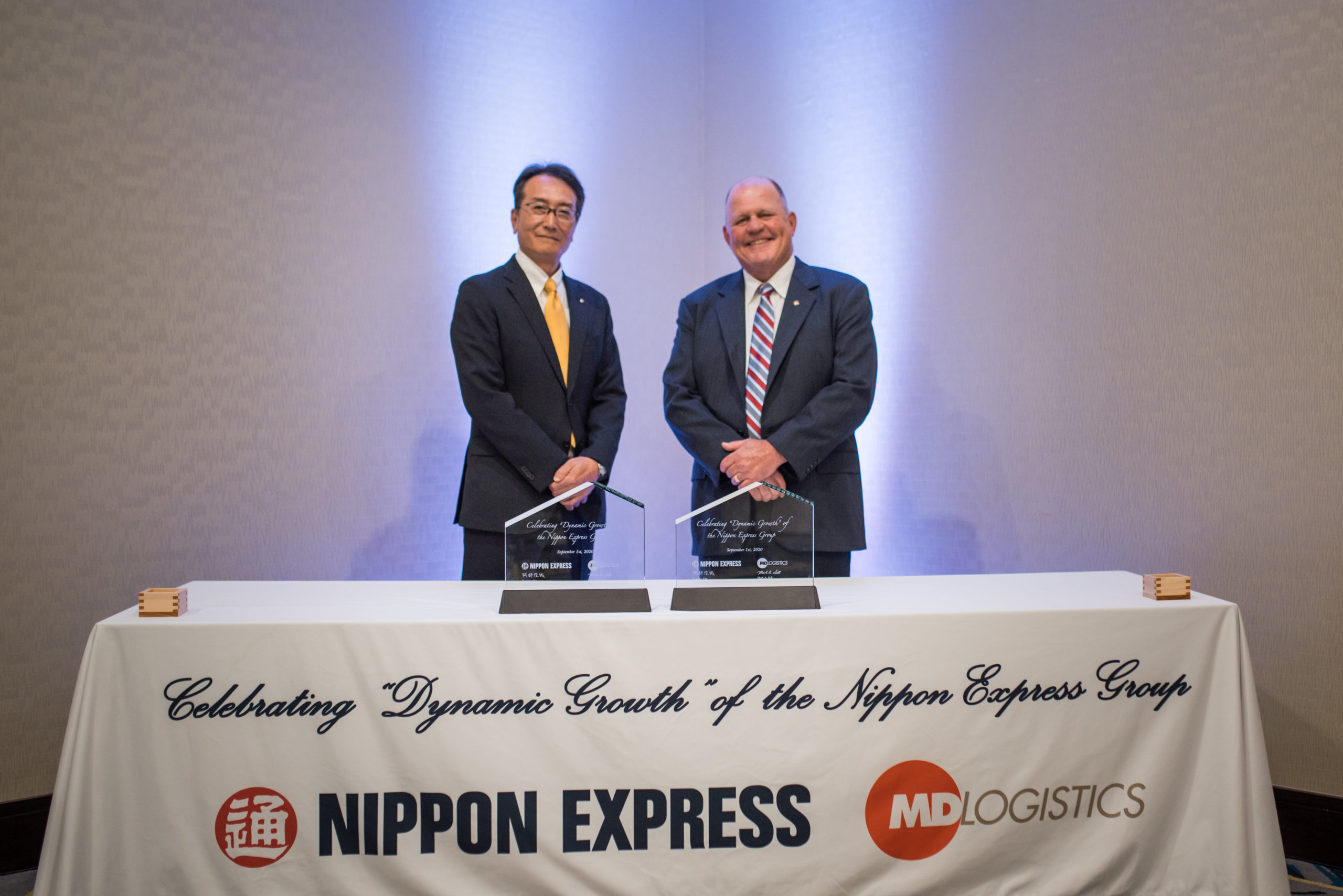 Toshiya Abe on the left and Mark Sell on the right at the Nippon Express and MD Logistics acquisition celebration