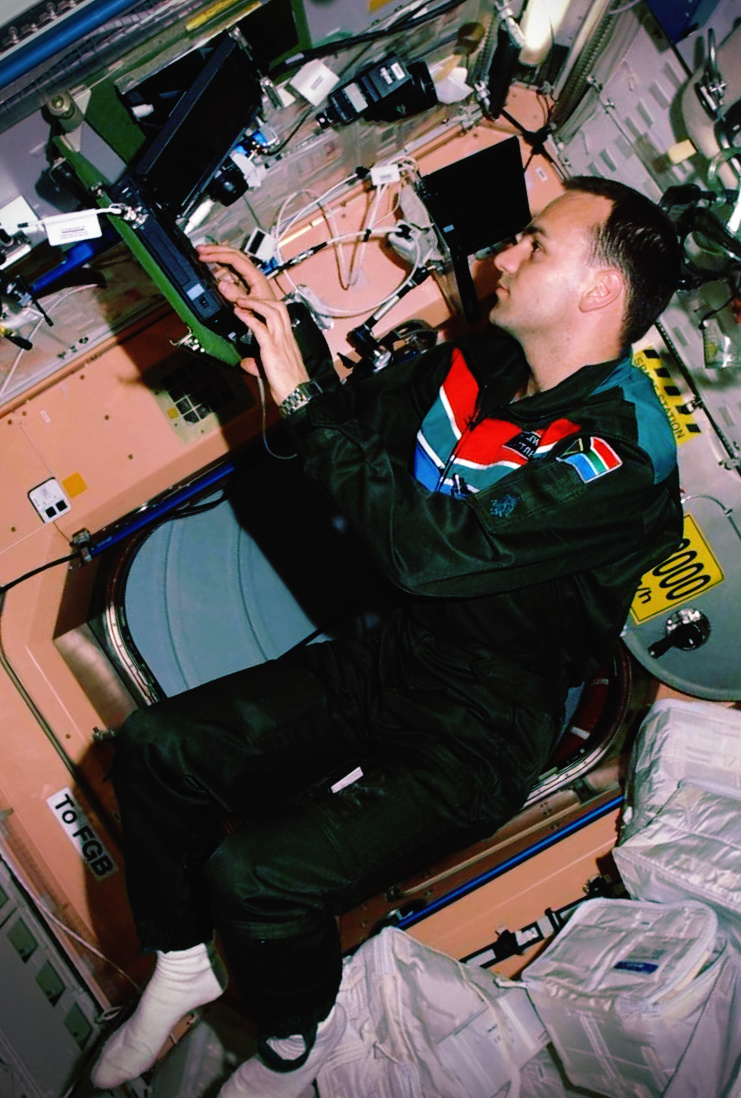 Mark Shuttleworth working at an IBM ThinkPad aboard the International Space Station in April 2002