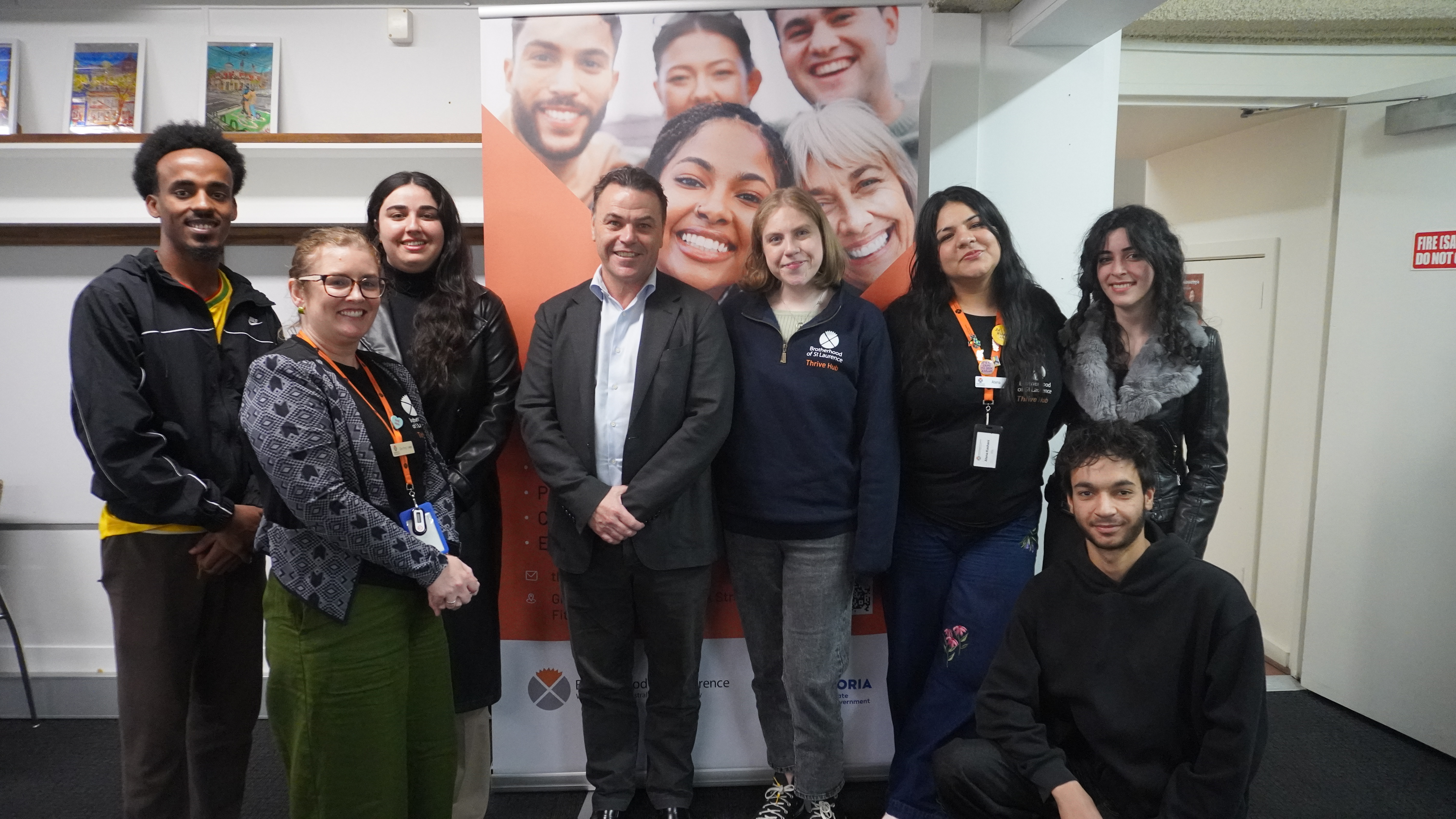 Mark Woodruff standing with Brotherhood of St. Laurence staff and Youth Advisors at the Fitzroy Thrive Hub