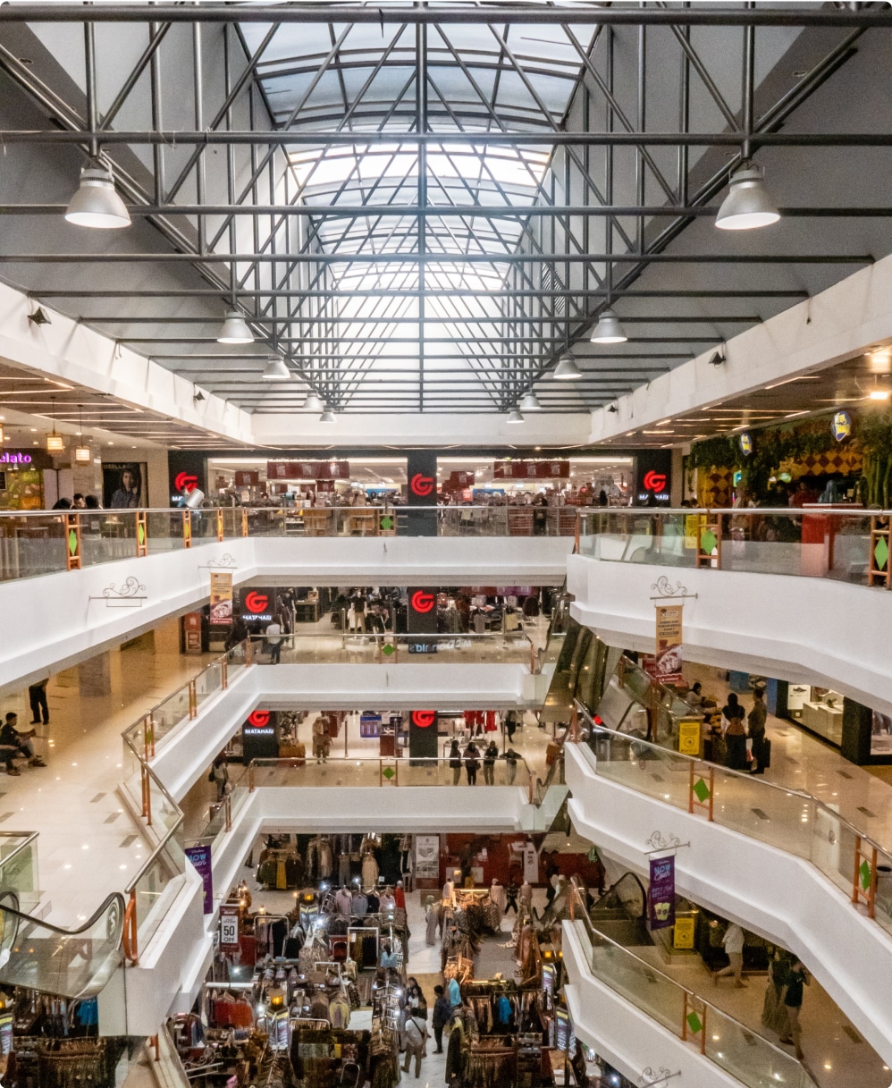 Interior of a multi-level shopping mall busy with shoppers and stores