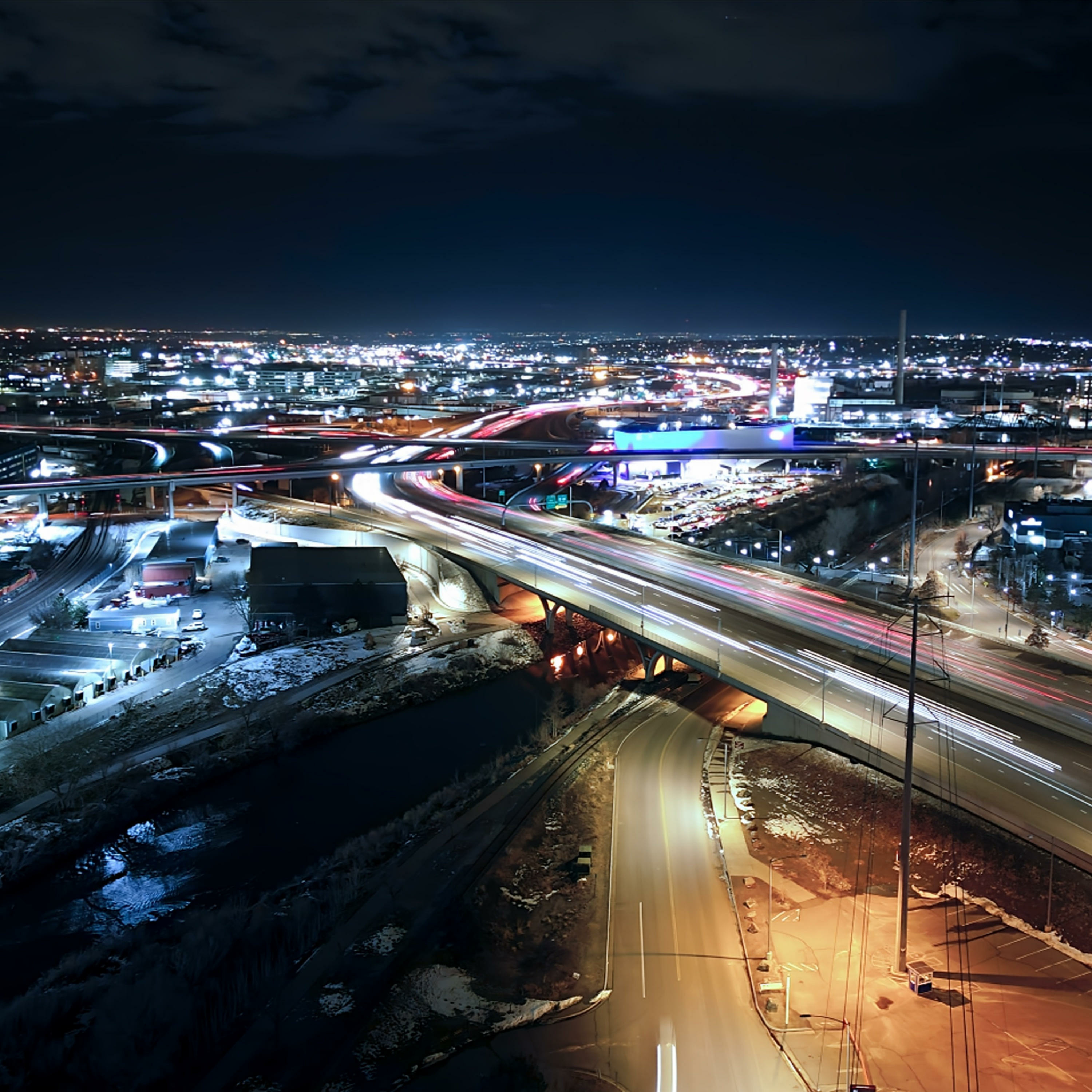 Nighttime city roads with long trails of vehicle lights, used as the Native of Denver-linked podcast artwork