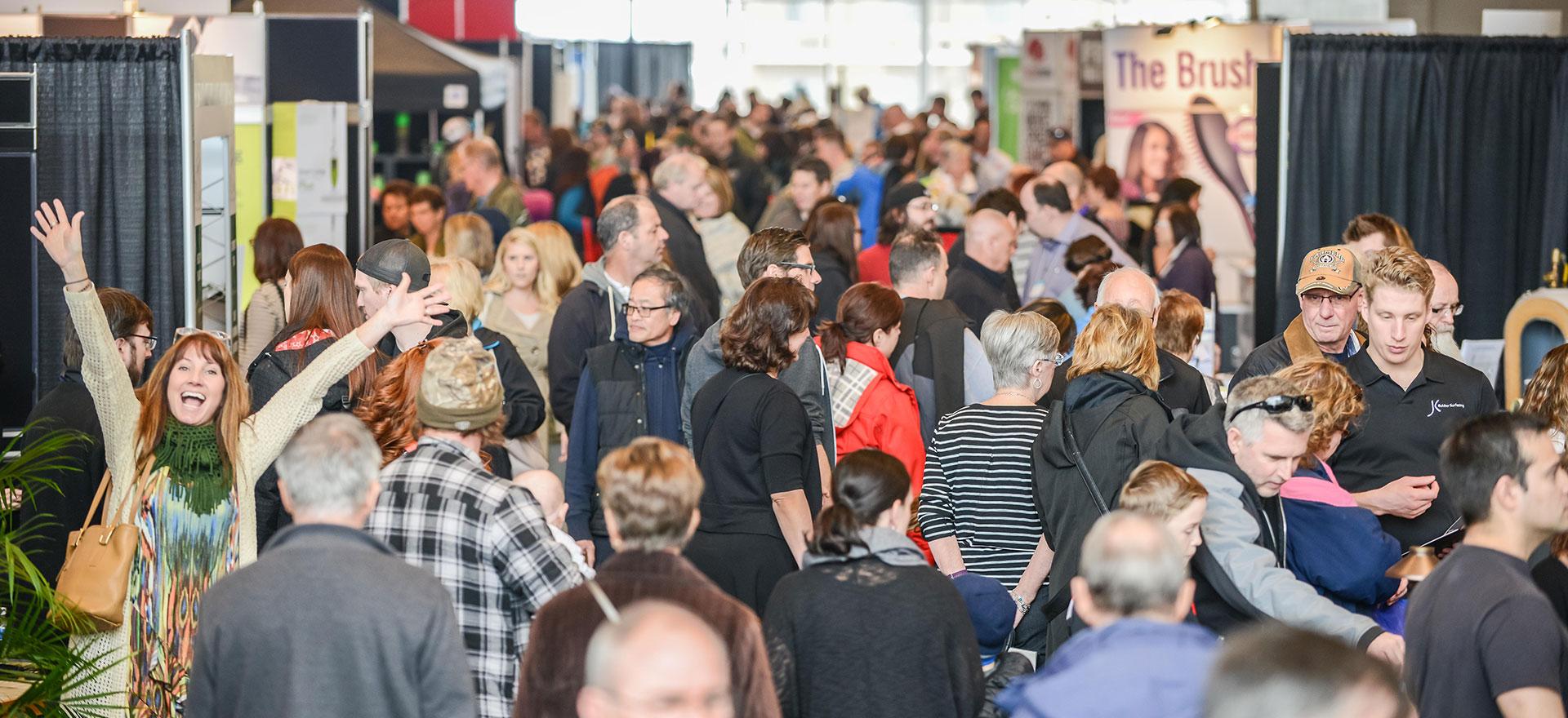 Visitors filling the aisles between exhibition booths at a Marketplace Events show