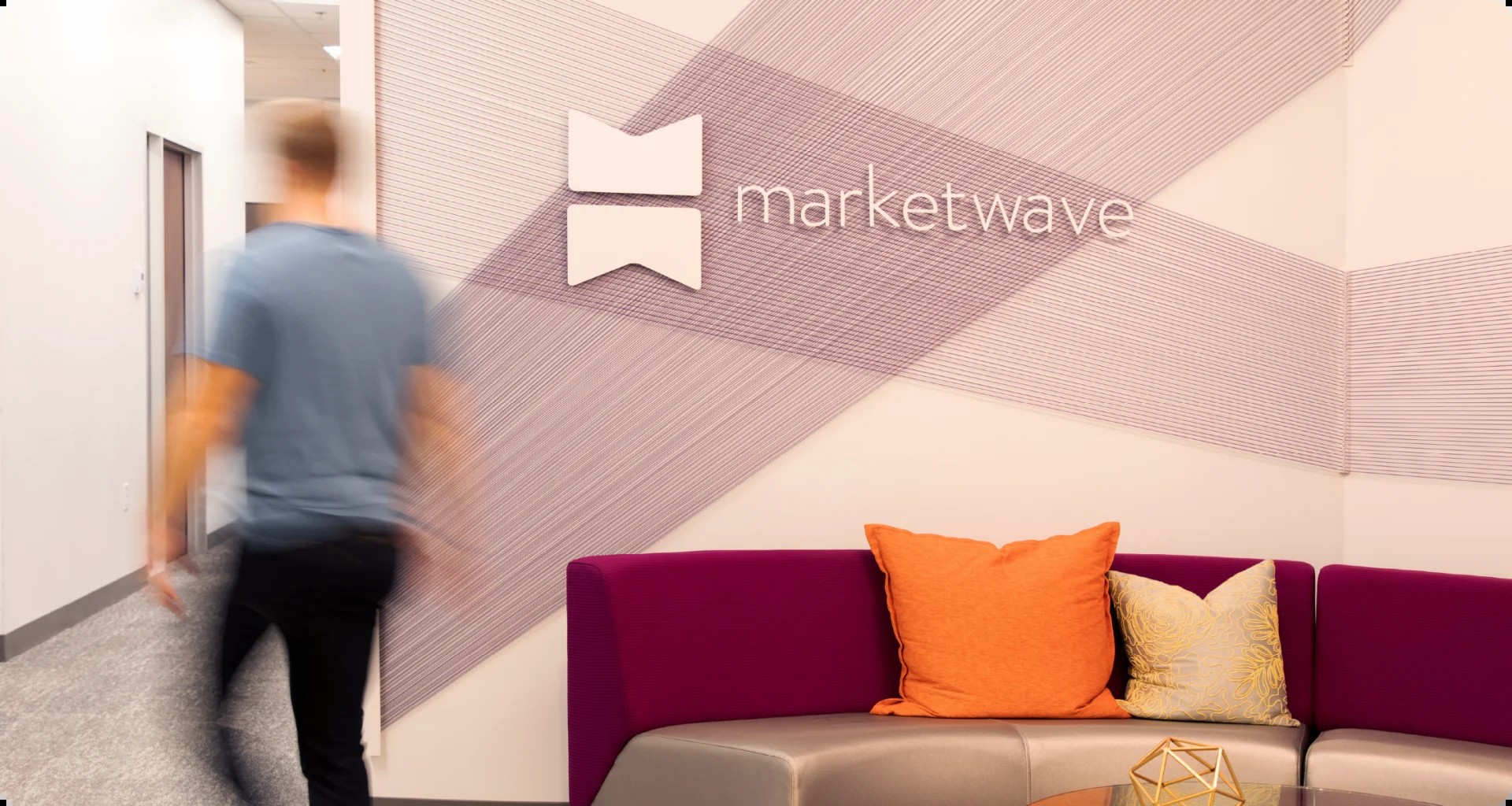 Marketwave colleagues talking in the agency office