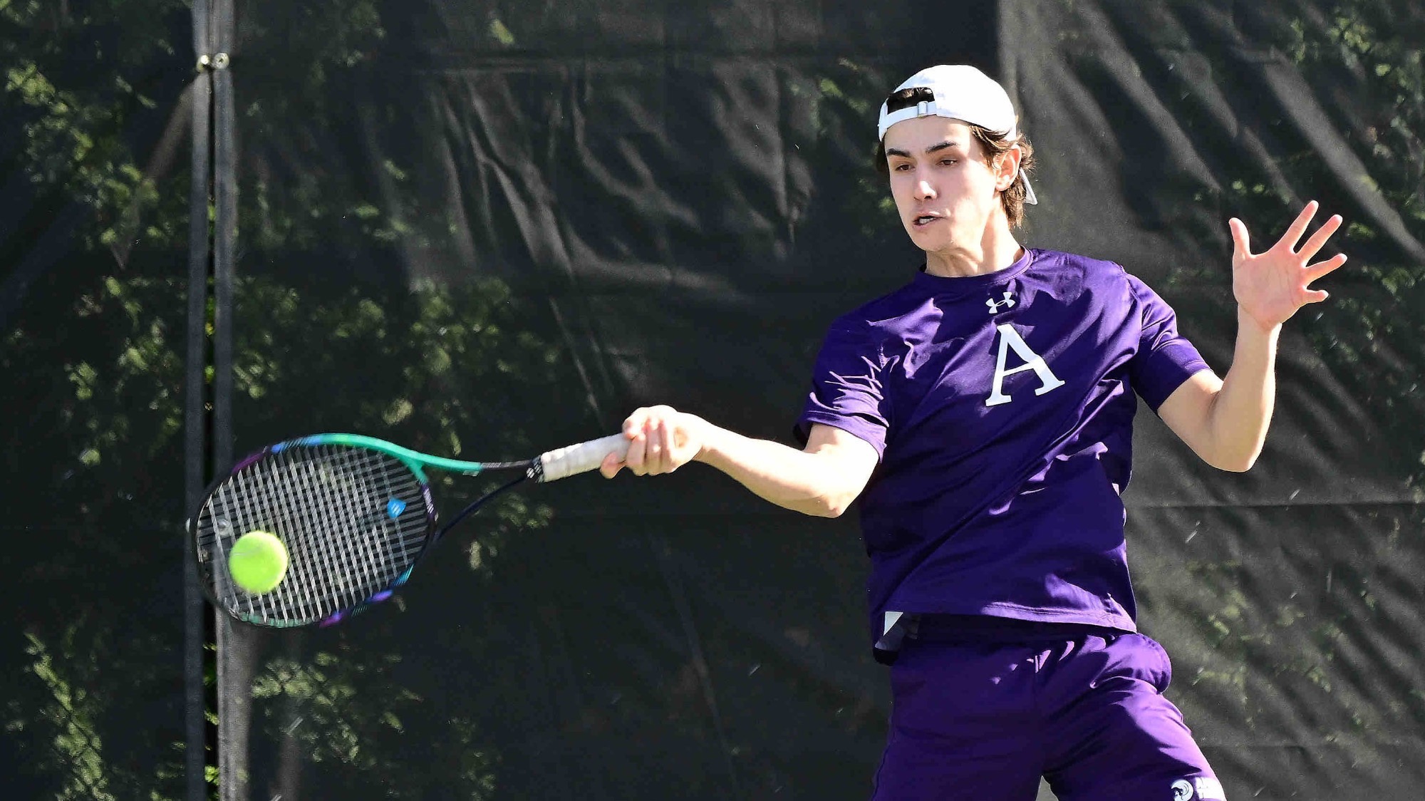 Marshall Leung striking a forehand for Amherst College men's tennis
