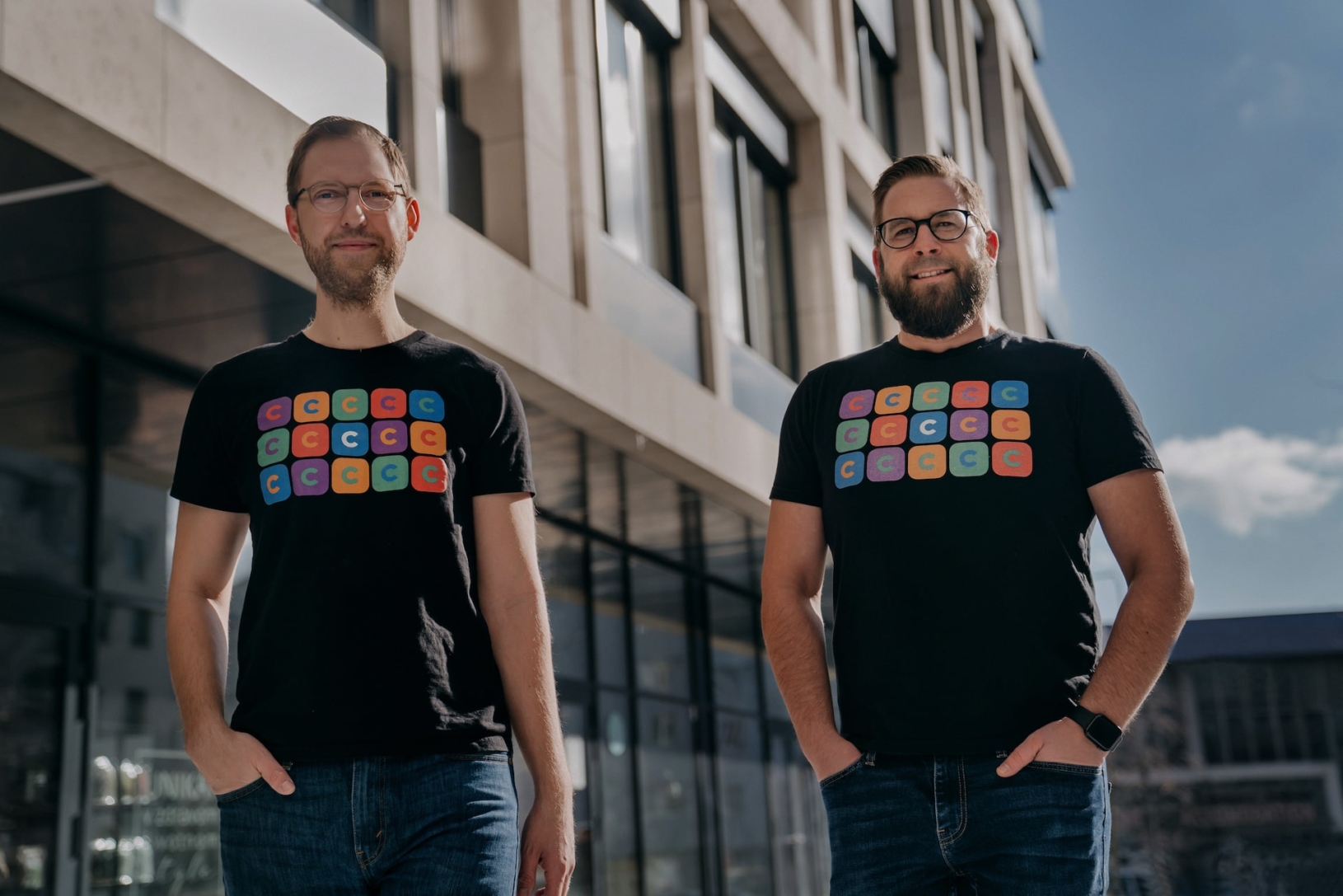 Martin Malych, left, and fellow CloudTalk co-founder Viktor Vanek standing outside in matching company T-shirts