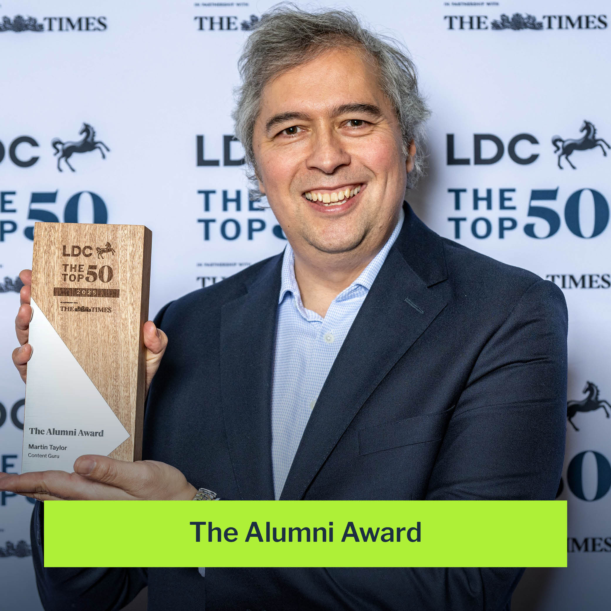 Martin Taylor holding the LDC Top 50 2025 Alumni Award in front of the event backdrop