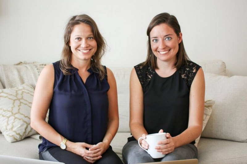 MealPal co-founders Katie Ghelli, left, and Mary Biggins, right, sitting together on a sofa