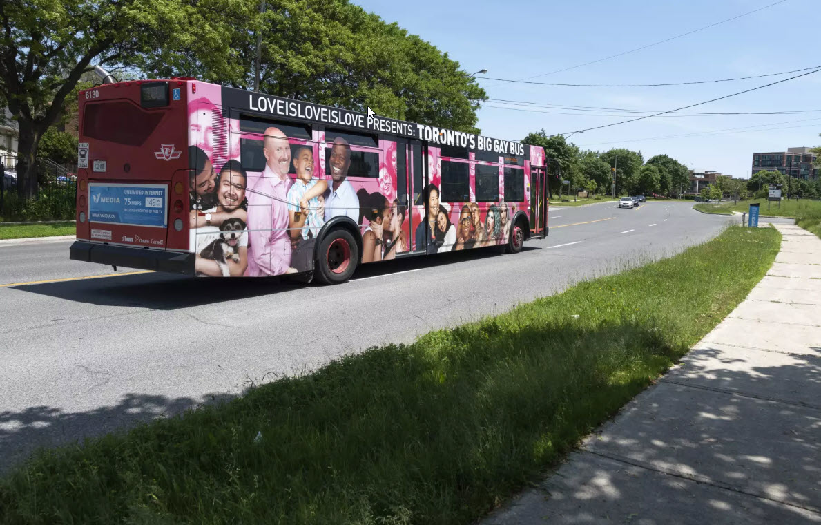 A colorfully wrapped Toronto transit bus used for the Big Gay Bus Pride campaign