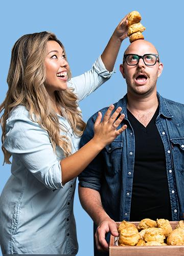 Ayeshah Abuelhiga playfully stacks biscuits on co-owner Ross Perkins’s head