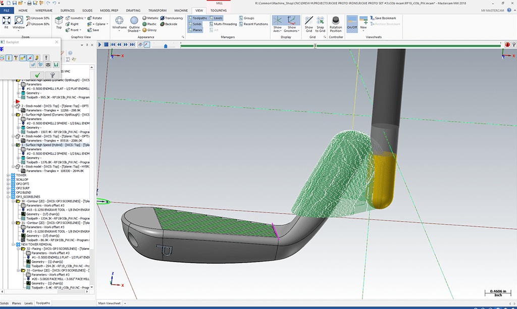 Mastercam simulation showing a cutter and toolpaths over a COBRA golf club head