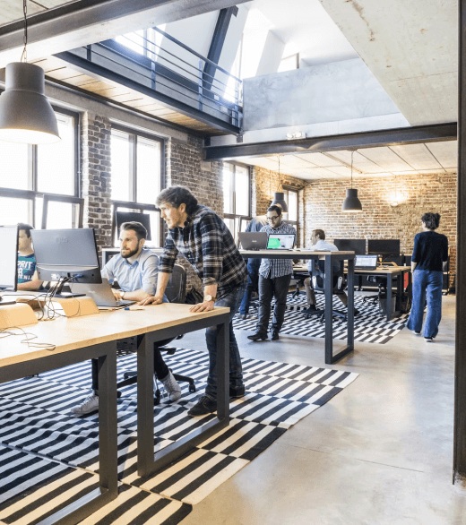 An open office with people working at desks, as illustrated on MatchPoint’s team page