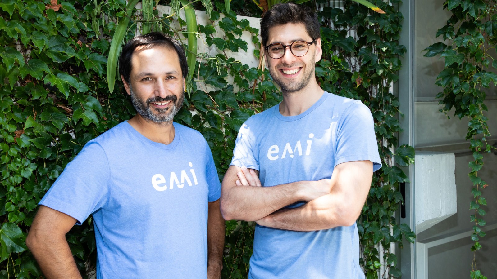 Emi Labs co-founders Andrés Arslanian and Mateo Cavasotto wearing blue Emi shirts
