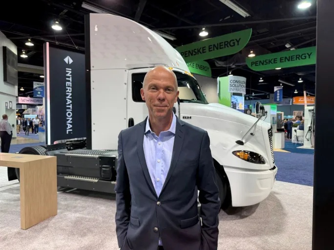 Mathias Carlbaum standing beside an International truck at ACT Expo 2025