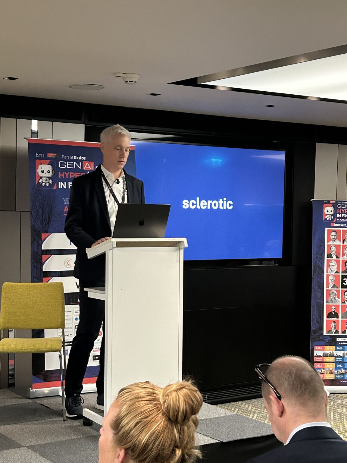 Mathias Strasser speaking behind a lectern at the Generative AI and Hyperautomation Summit in June 2025