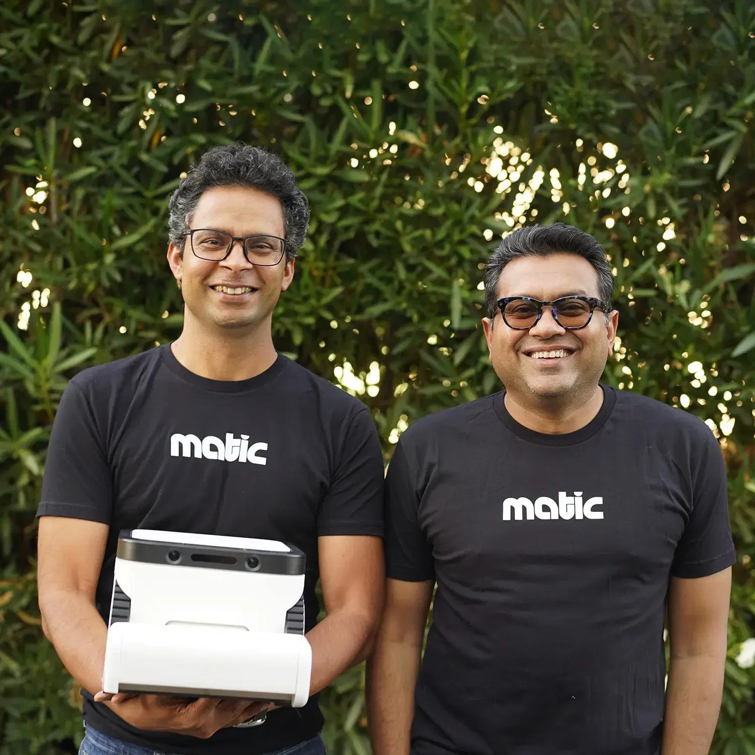 Matic co-founders Navneet Dalal and Mehul Nariyawala holding the Matic robot outdoors