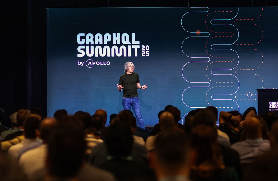 Matt DeBergalis speaking onstage at GraphQL Summit 2025 before a seated audience