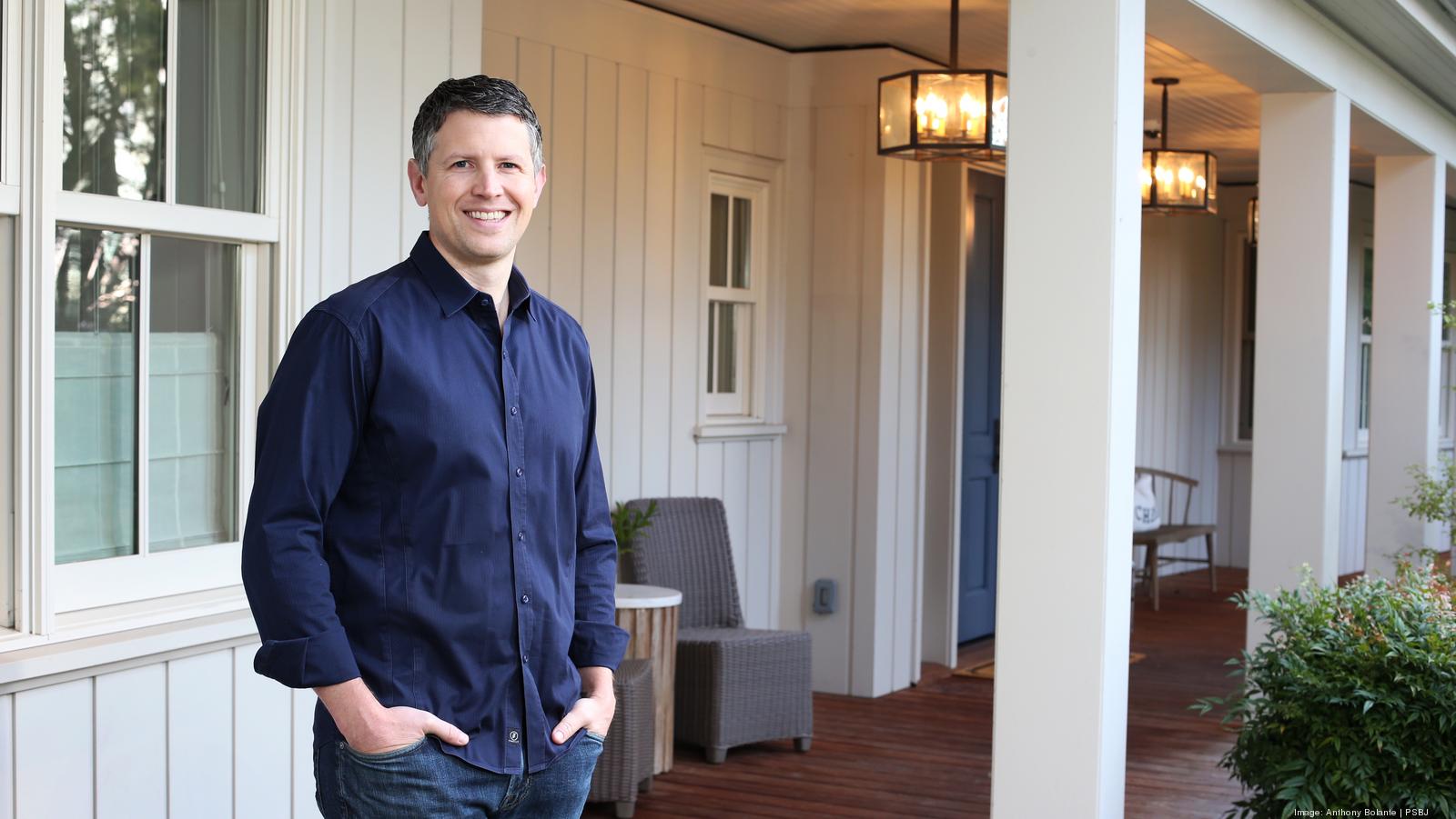 Matt Ehrlichman standing on a covered residential porch in a navy shirt