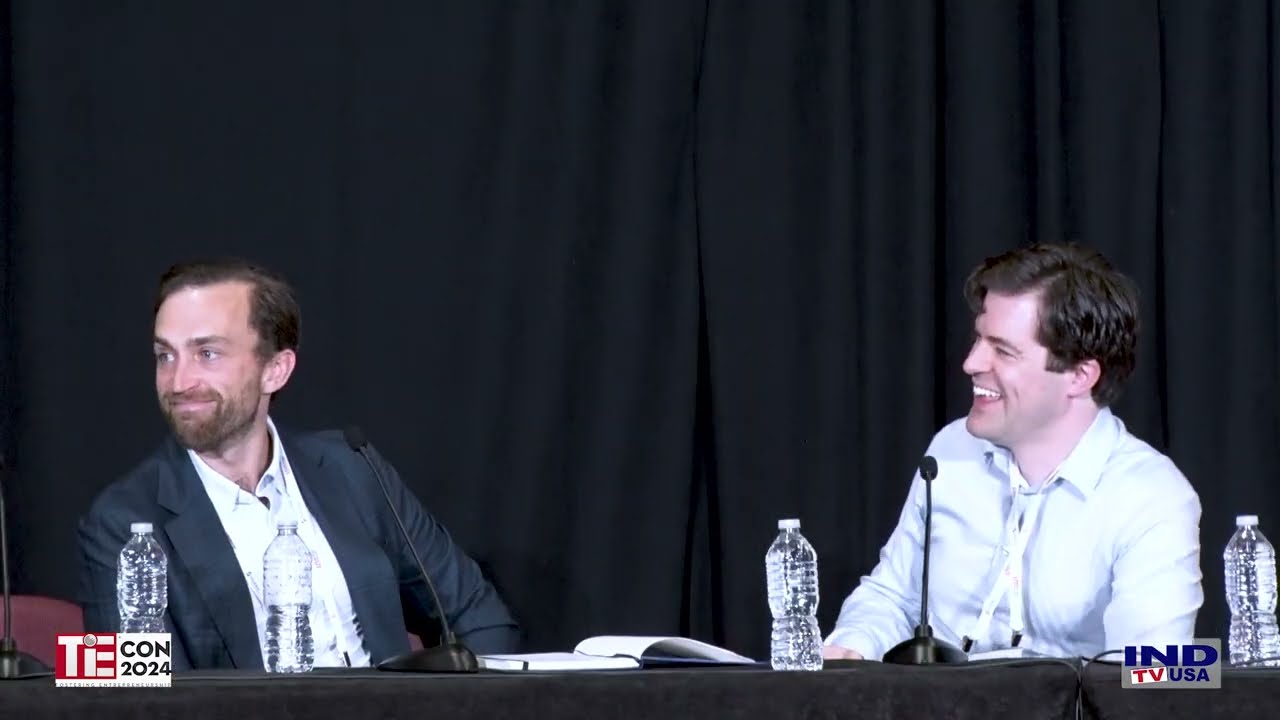 Matt Hollingsworth, right, smiling on stage beside moderator Pete Sletteland at TiEcon 2024