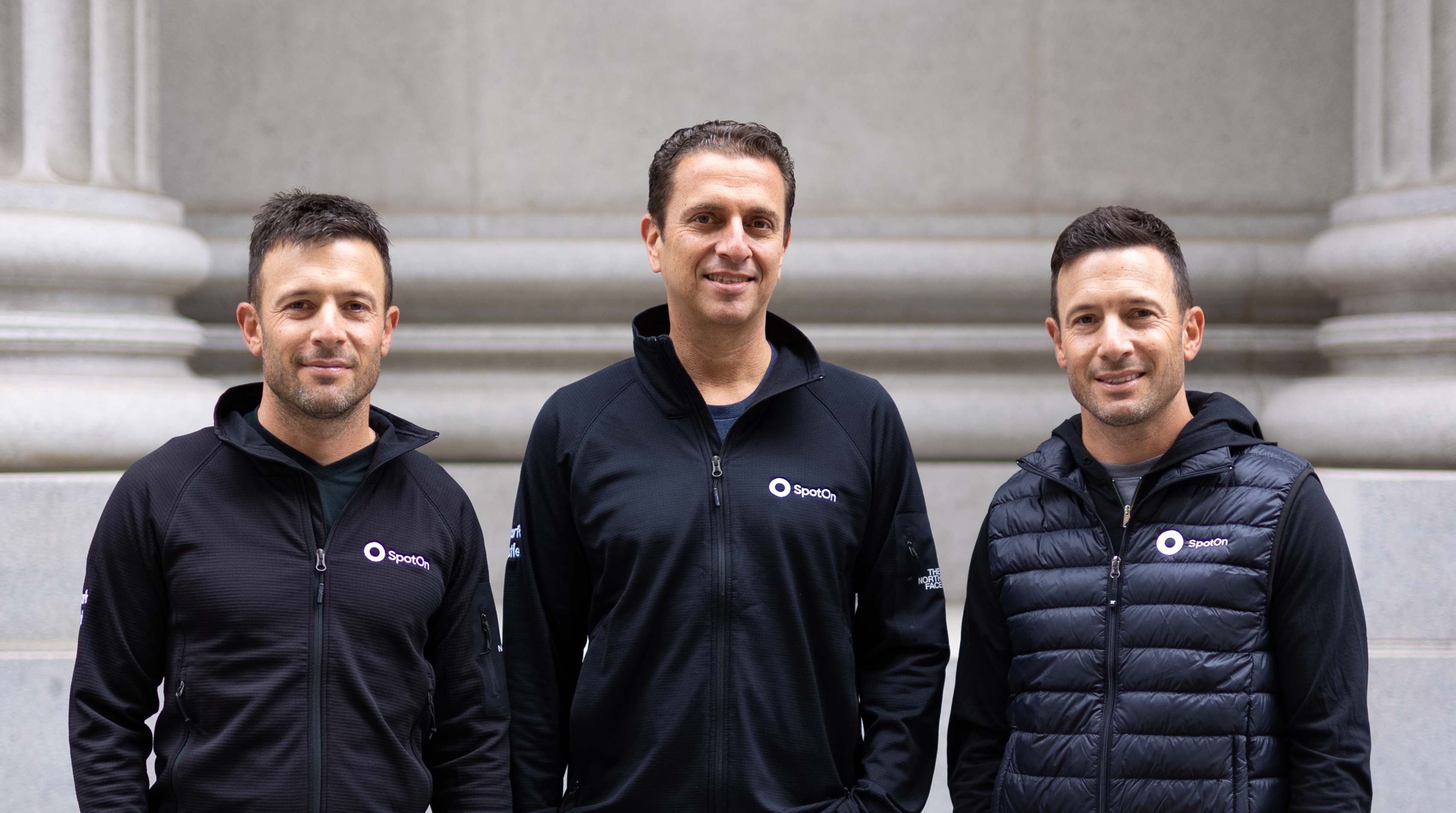 SpotOn co-founders Zach Hyman, Doron Friedman and Matt Hyman standing together in company jackets