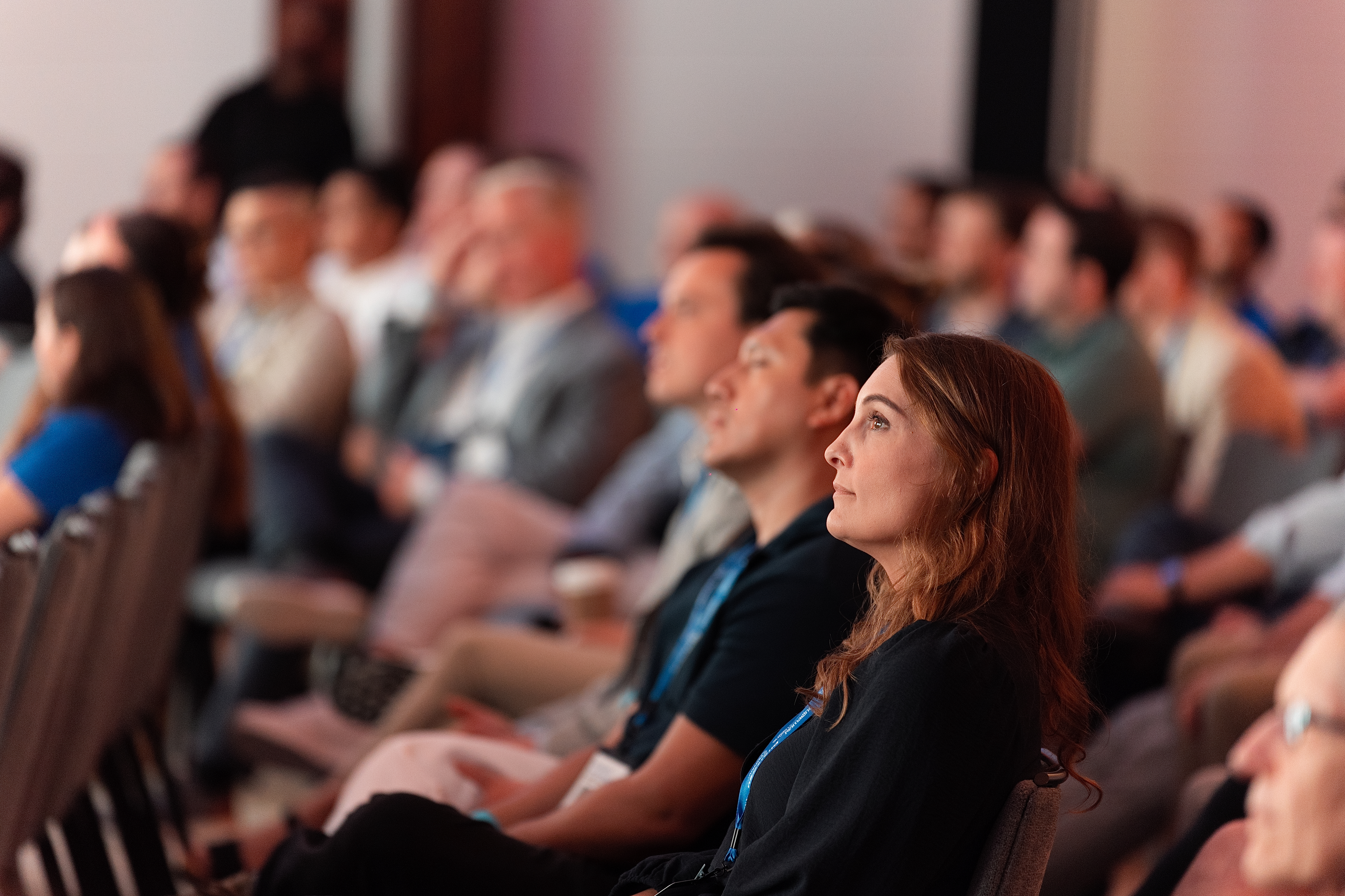 Audience members listening during Neostella’s NeoSummit 2026 conference