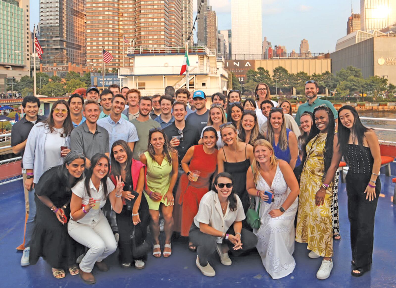 MKTG colleagues gathered on a boat with the New York skyline behind them