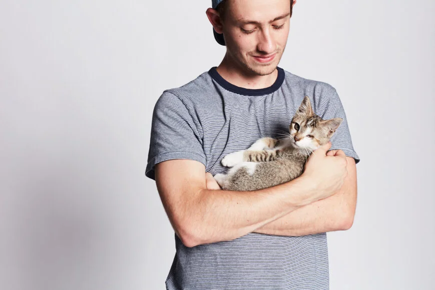 Matt Michaelson holding Ruby, a tabby cat