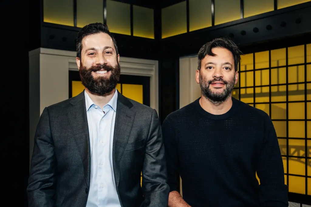 Matt Pavelle, left, standing with Doctronic co-founder Adam Oskowitz