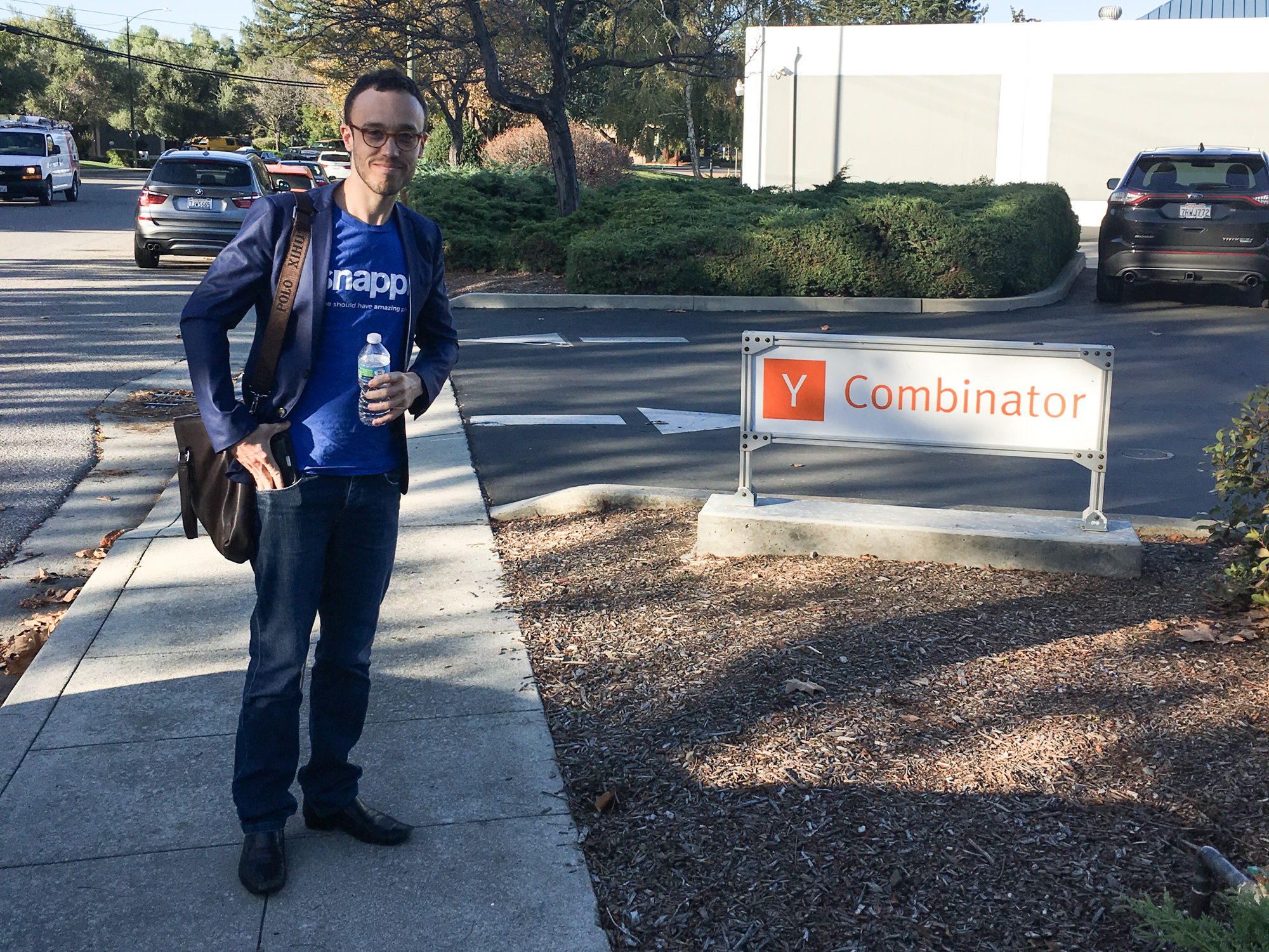Matt Schiller standing outside Y Combinator in a blue Snappr T-shirt and jacket