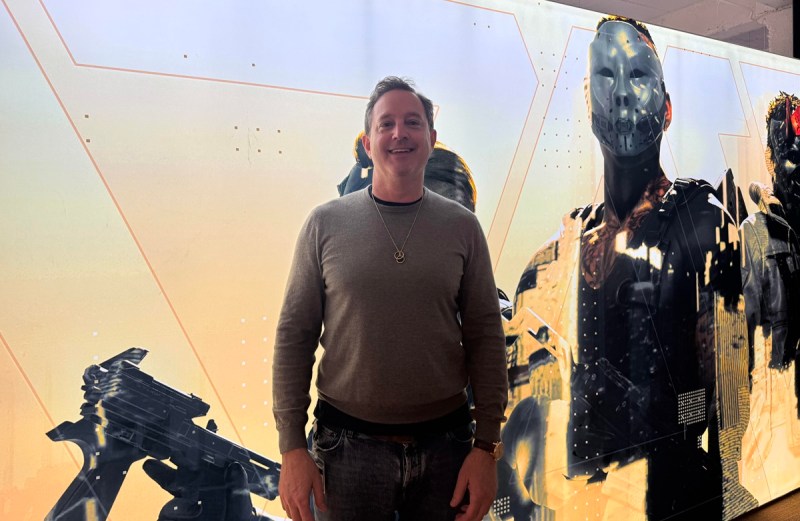 Matthew Bromberg at Unity’s San Francisco headquarters, standing beside a large science-fiction character display