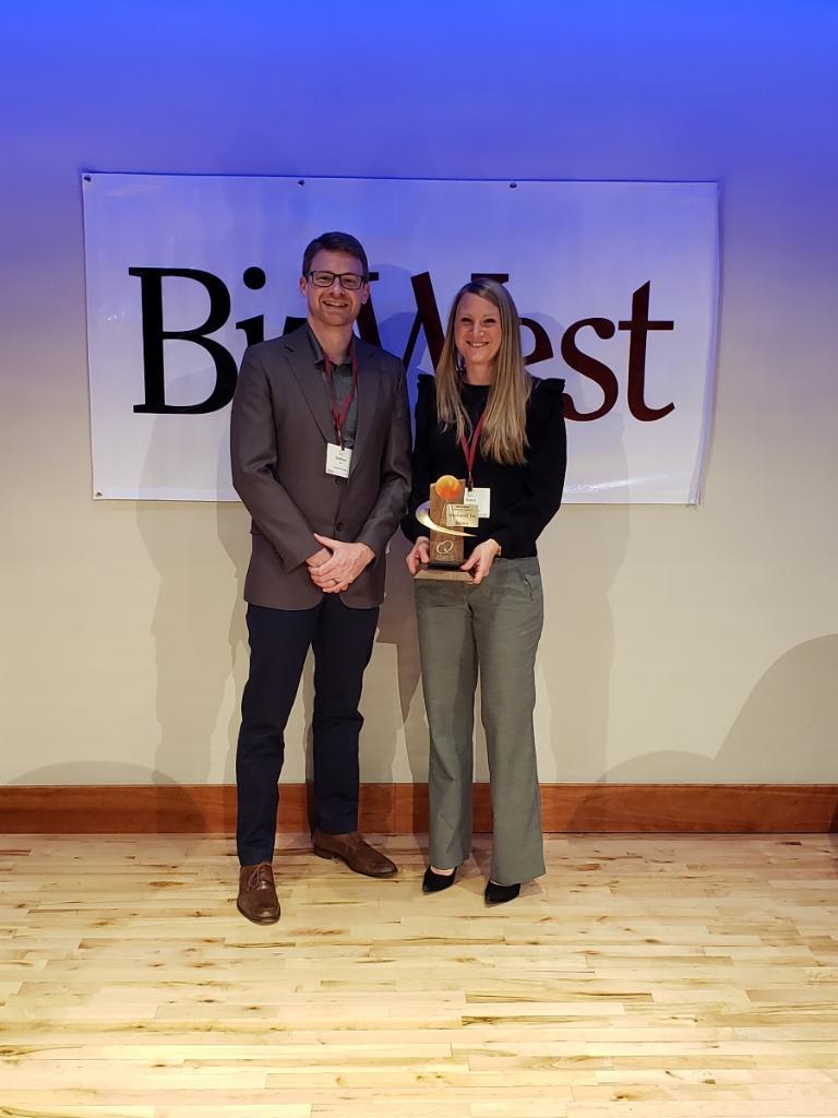 Matthew Irvin and a Maplewell colleague holding the company's BizWest IQ Award onstage