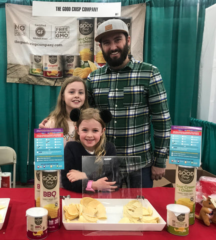 Matthew Parry with two of his daughters at a Good Crisp Company trade-show booth