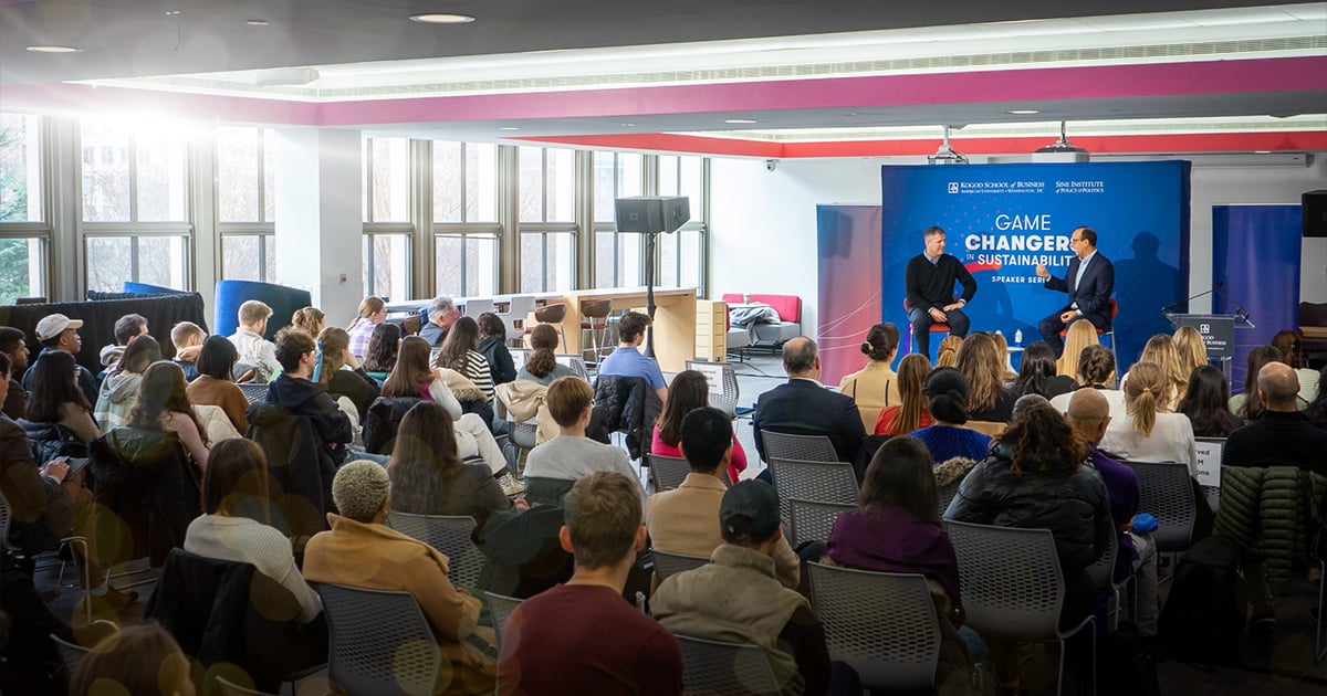 Matthew Pine and dean David Marchick speaking before an audience at American University