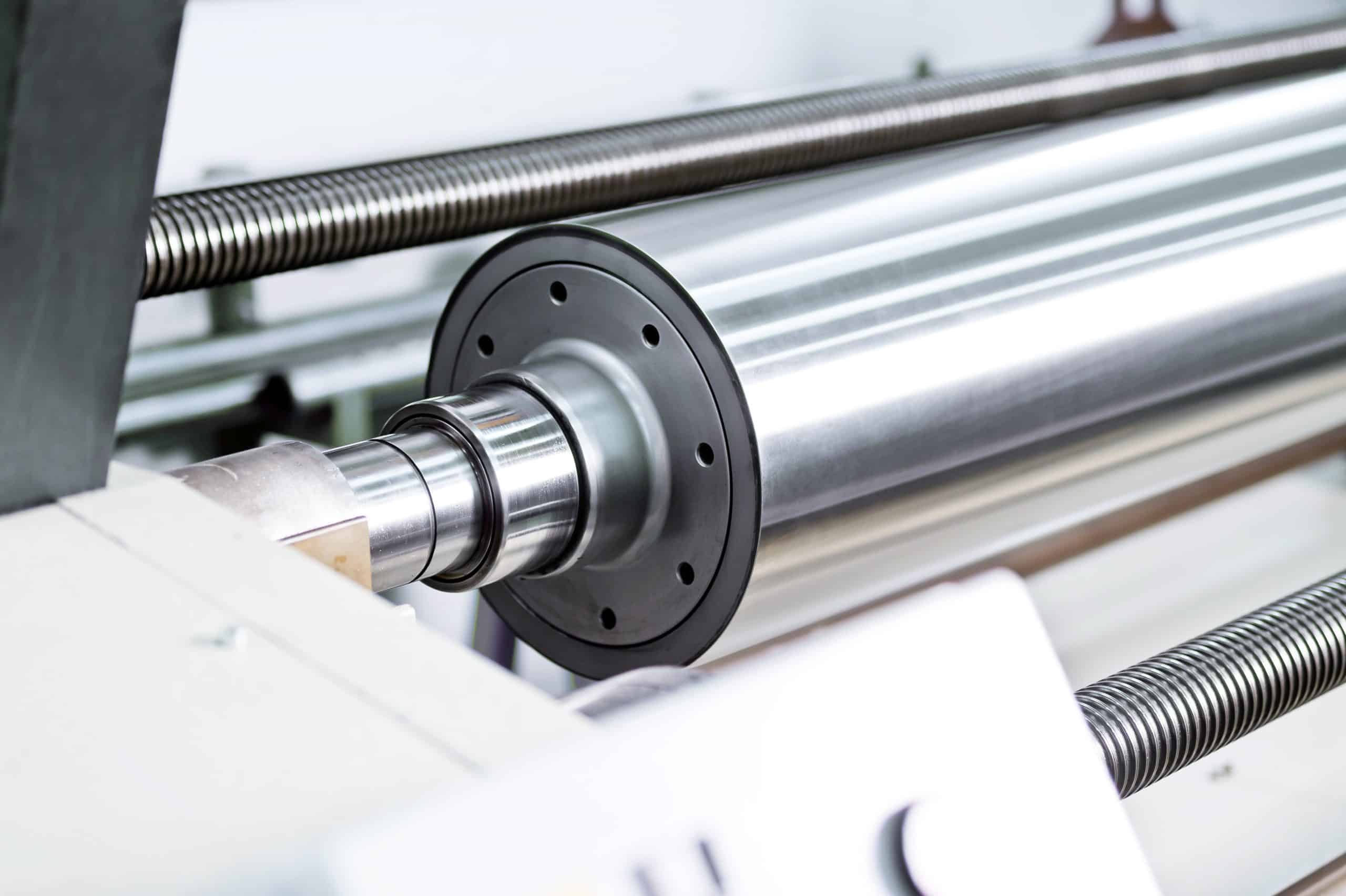 Close view of a polished technical roller in Matthews Engineering equipment