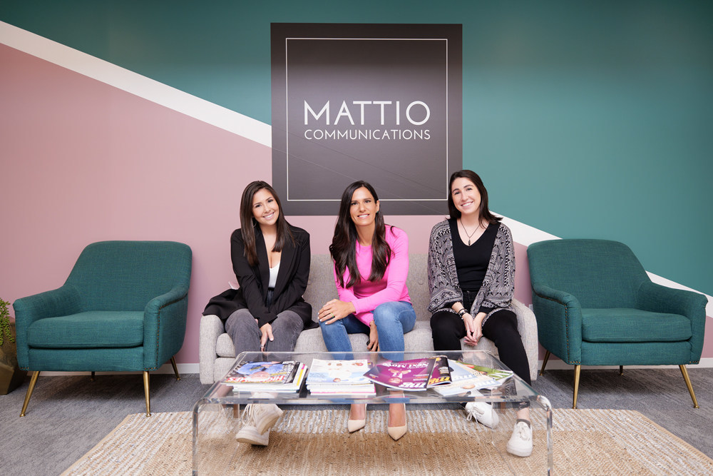 Rosie Mattio and colleagues seated in the MATTIO Communications office in 2021