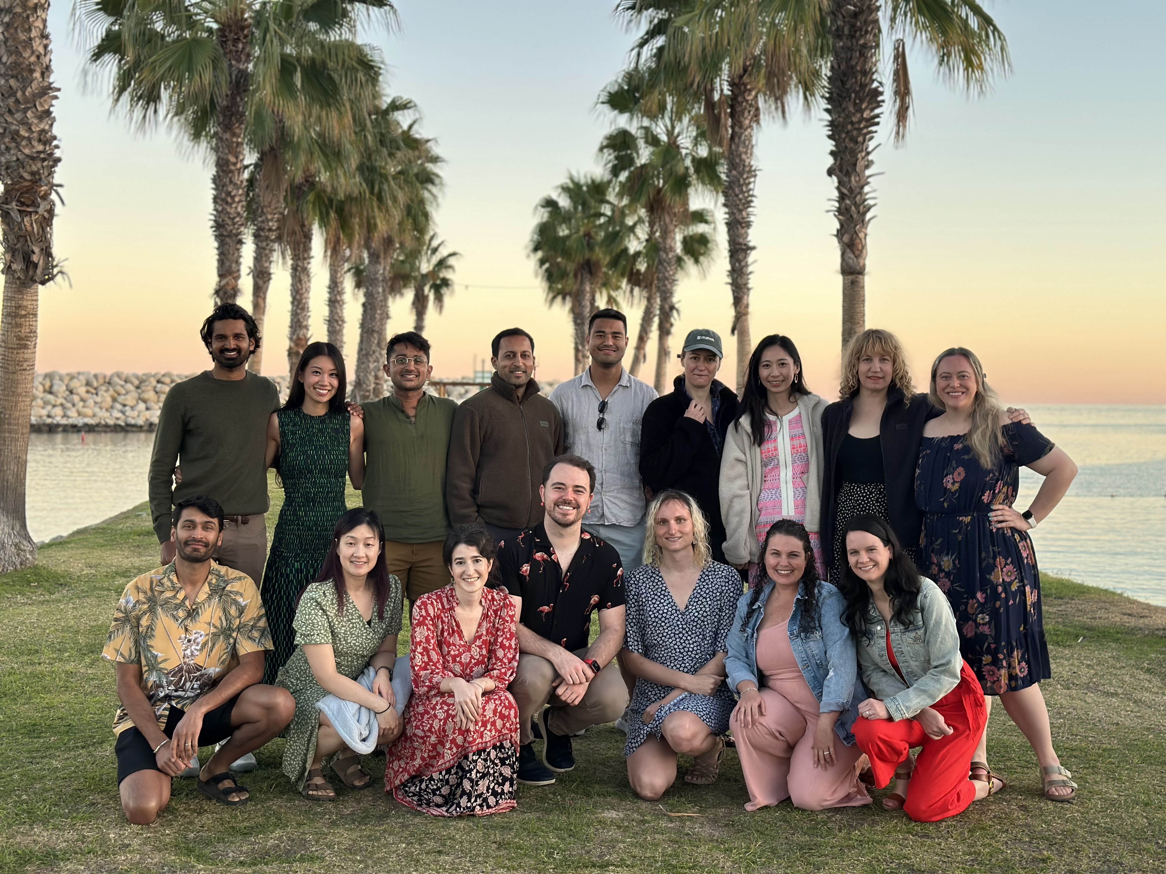 Maven team gathered under palm trees at their February 2025 offsite in San José del Cabo