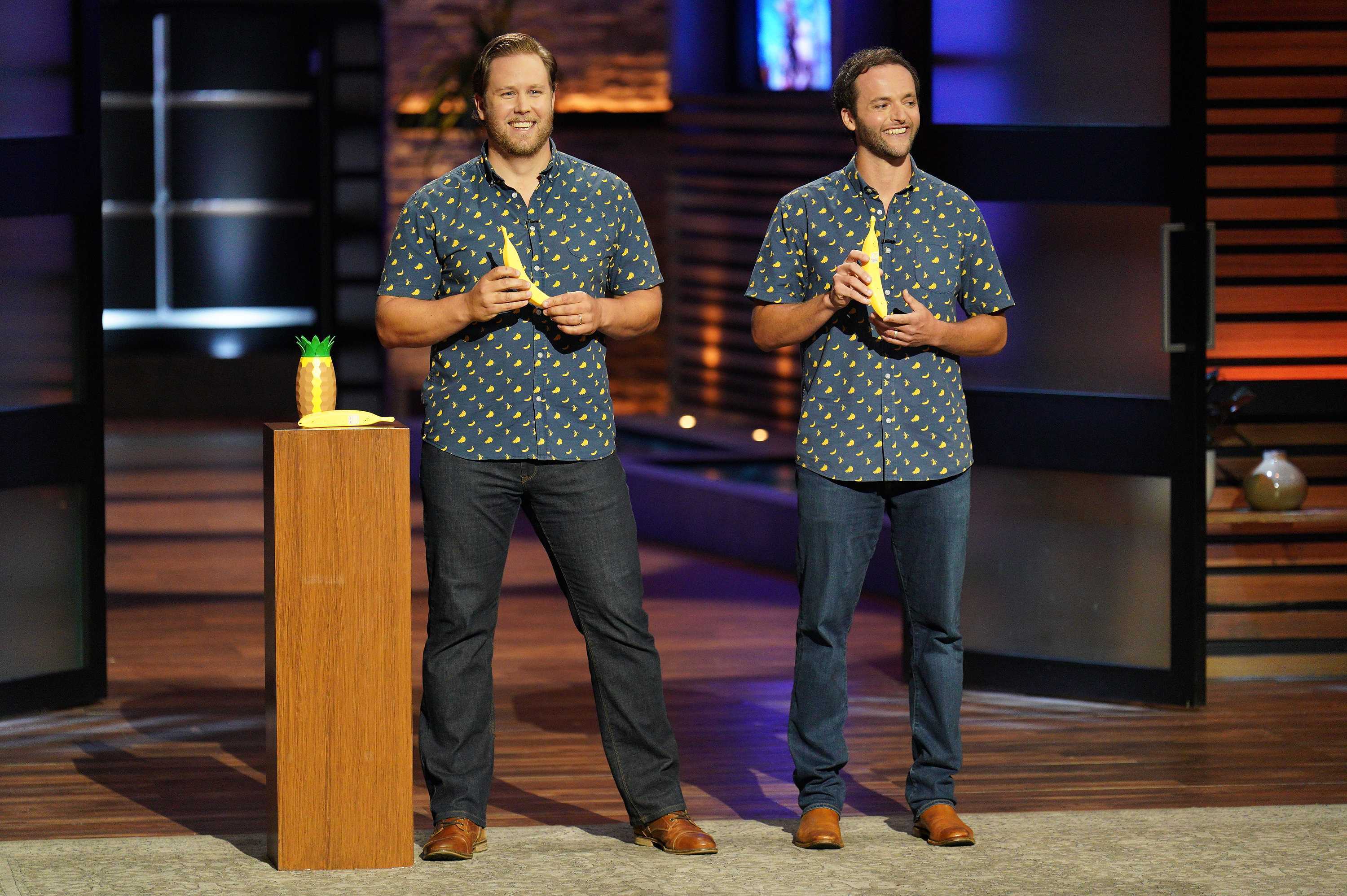 Max Brown, left, and Brian Brunsing holding banana-shaped handsets in matching banana-print shirts on Shark Tank
