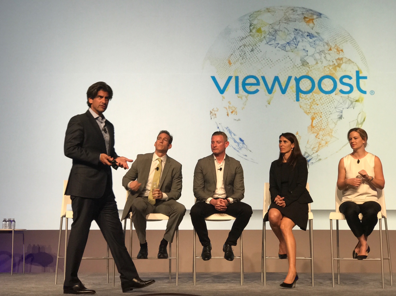 Max Eliscu standing at left, speaking to a seated panel at a Visa Payments Forum
