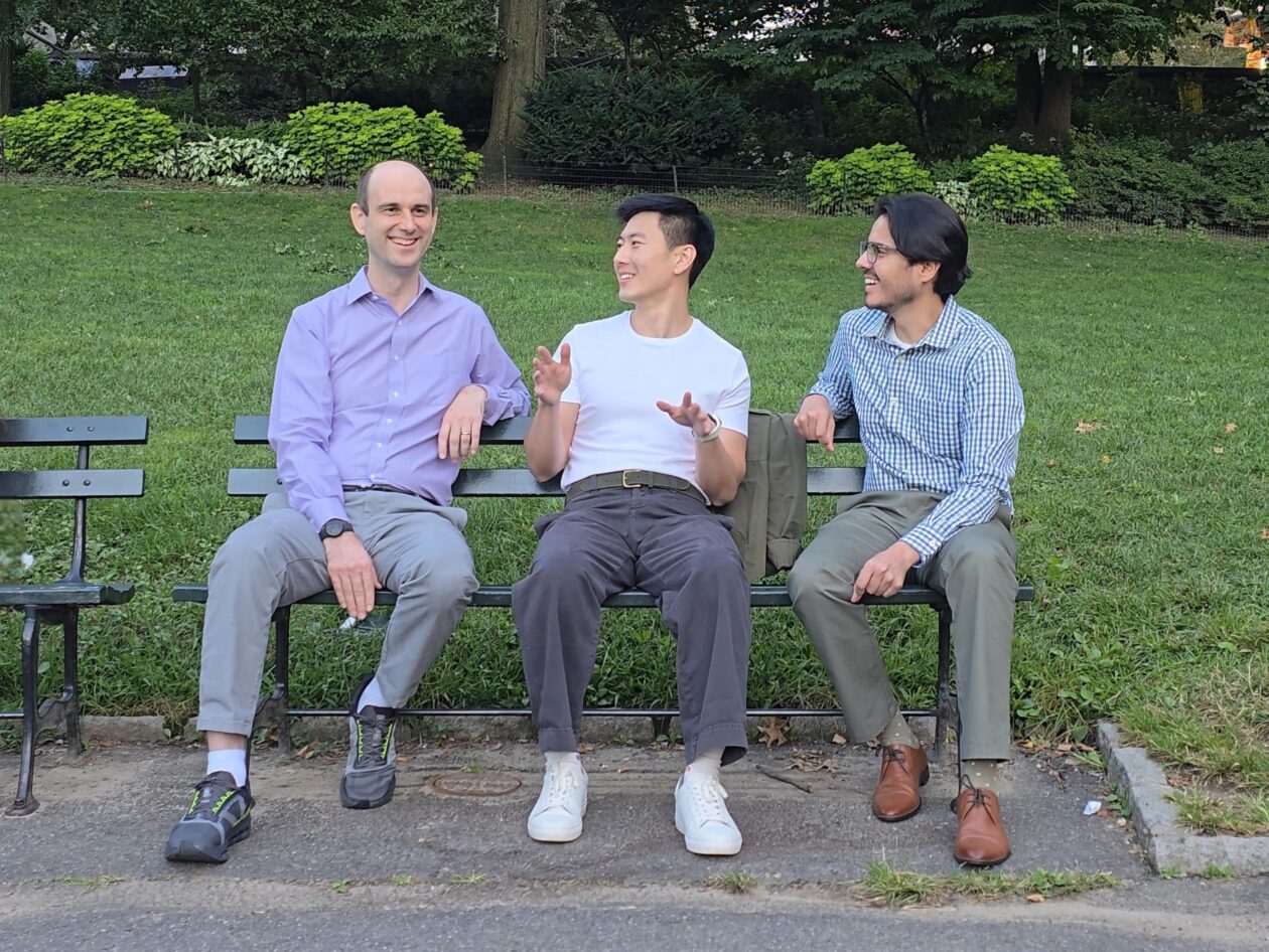 Meadow AI co-founders Dragos Velicanu, Max Jai Sim and Abbas Guvenilir sitting together on a park bench