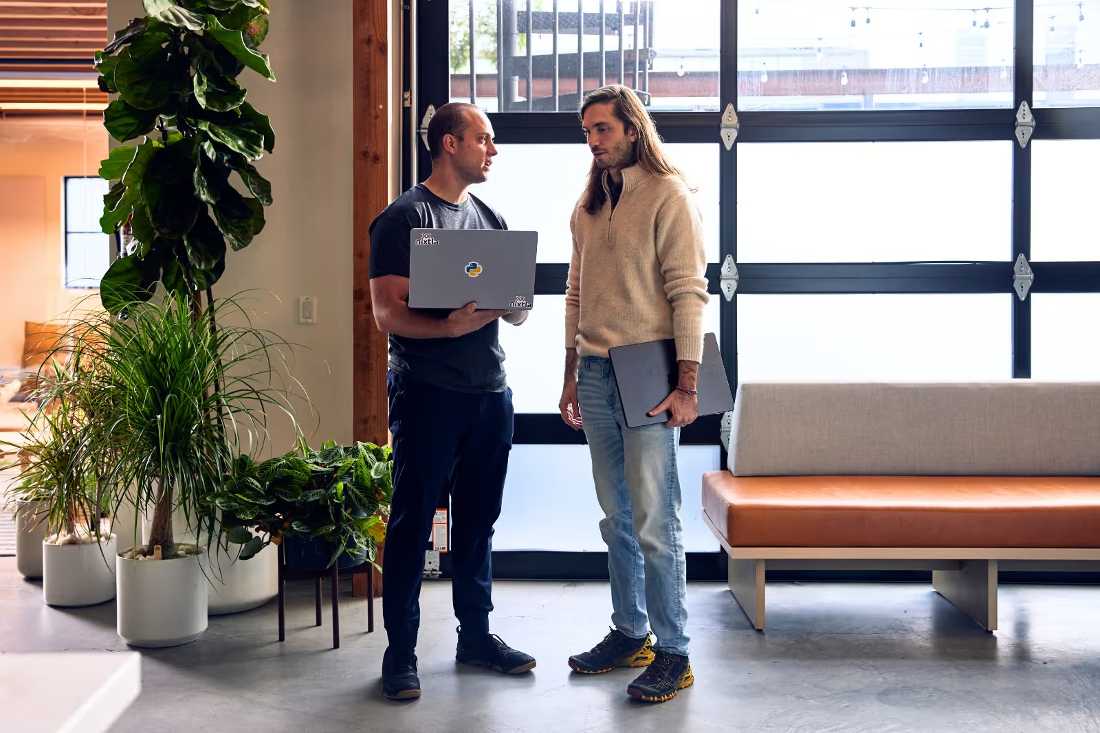 Max Mergenthaler Canseco, left, and Cristian Challu standing together with laptops