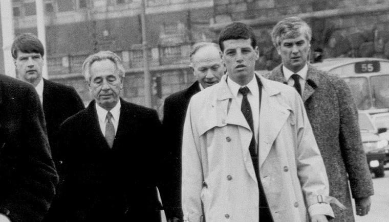Archival black-and-white photograph of a protective entourage, reproduced in MAX’s company history
